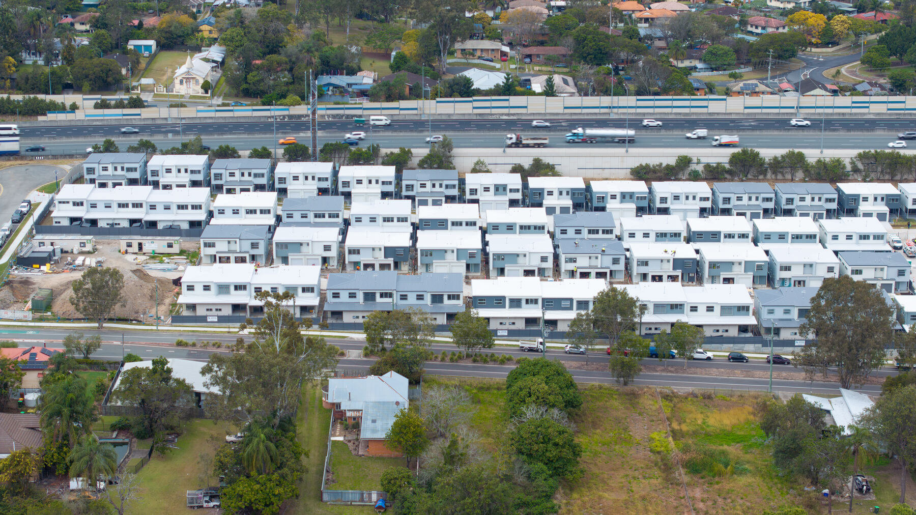 Aerial drone view of a completed multi-dwelling townhouse development in Brisbane, showcasing the full scale of a JET Metal Fabrication project