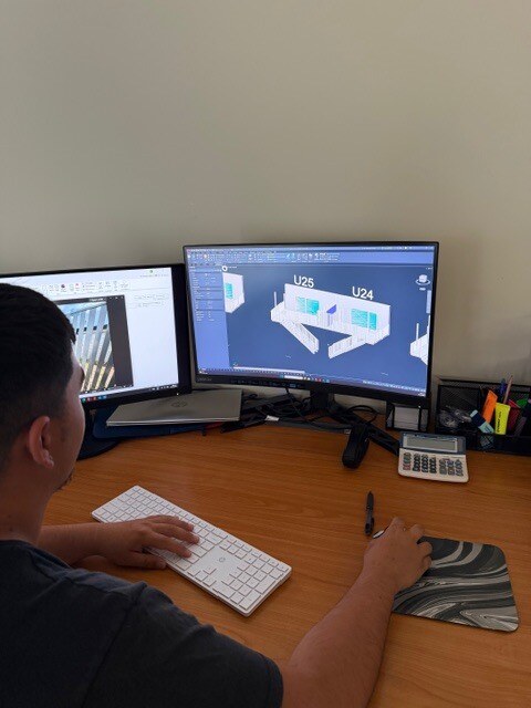 JET Metal Fabrication team member designing a project in CAD at the office workstation