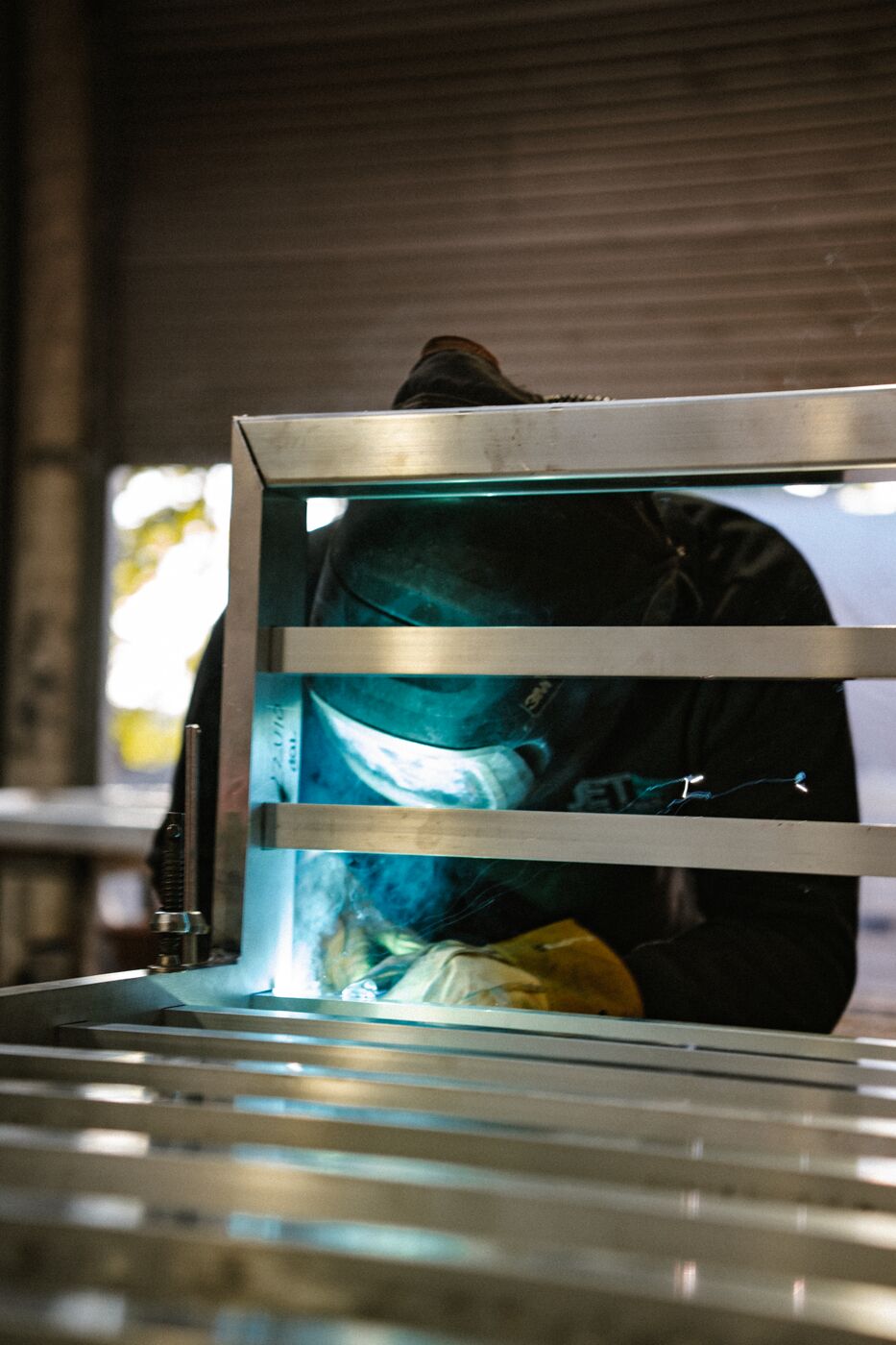 JET Metal Fabrication team member welding an aluminium gate frame in the workshop
