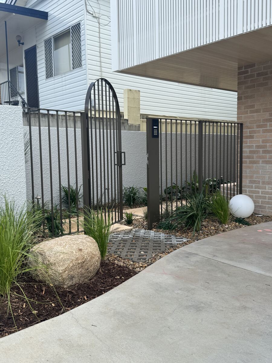 Custom arched black aluminium garden gate with decorative finial