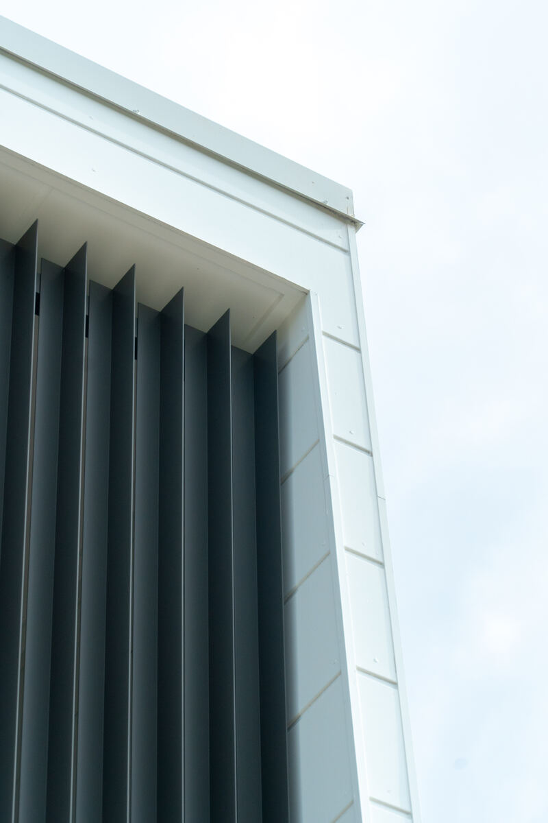 Upward angle of a completed townhouse gable with vertical aluminium screening