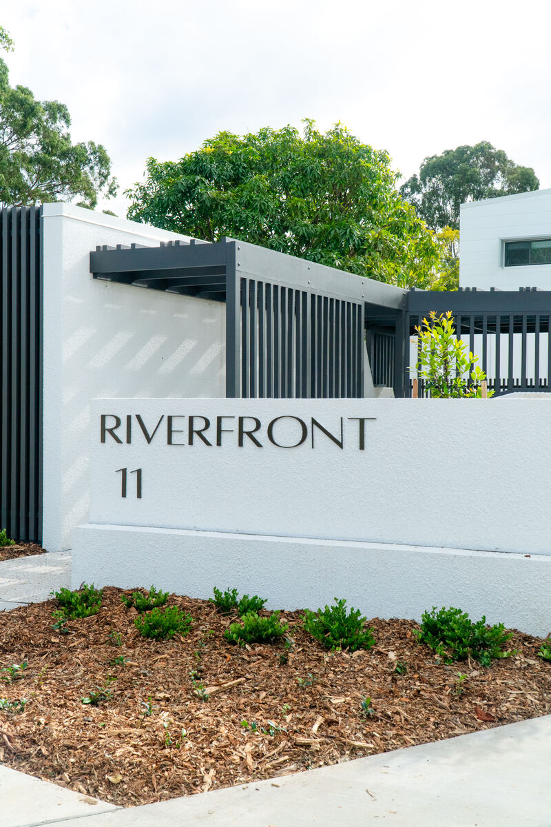 Riverview development entrance signage with custom screening and fencing